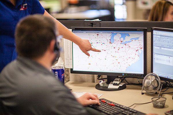 Dispatchers tracking trucks on a route map