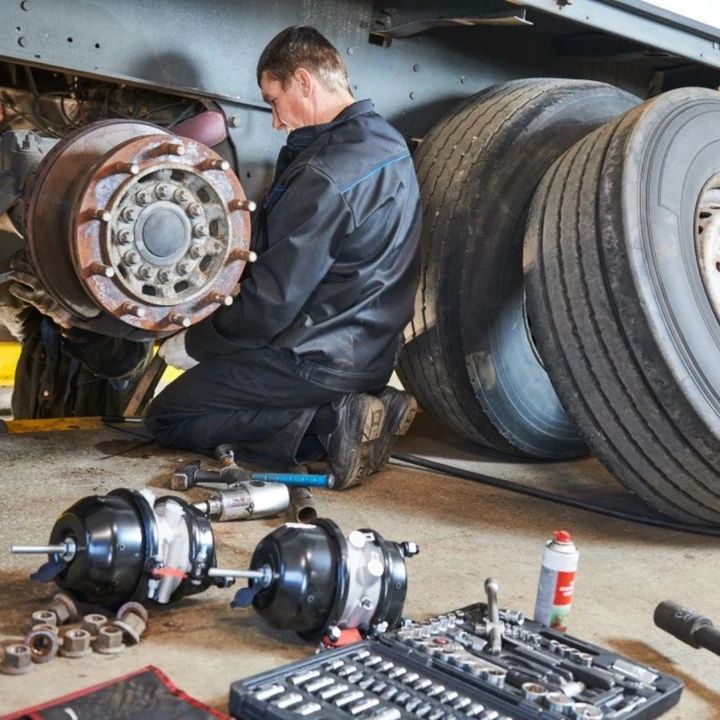 Technician working on a trailer's brakes