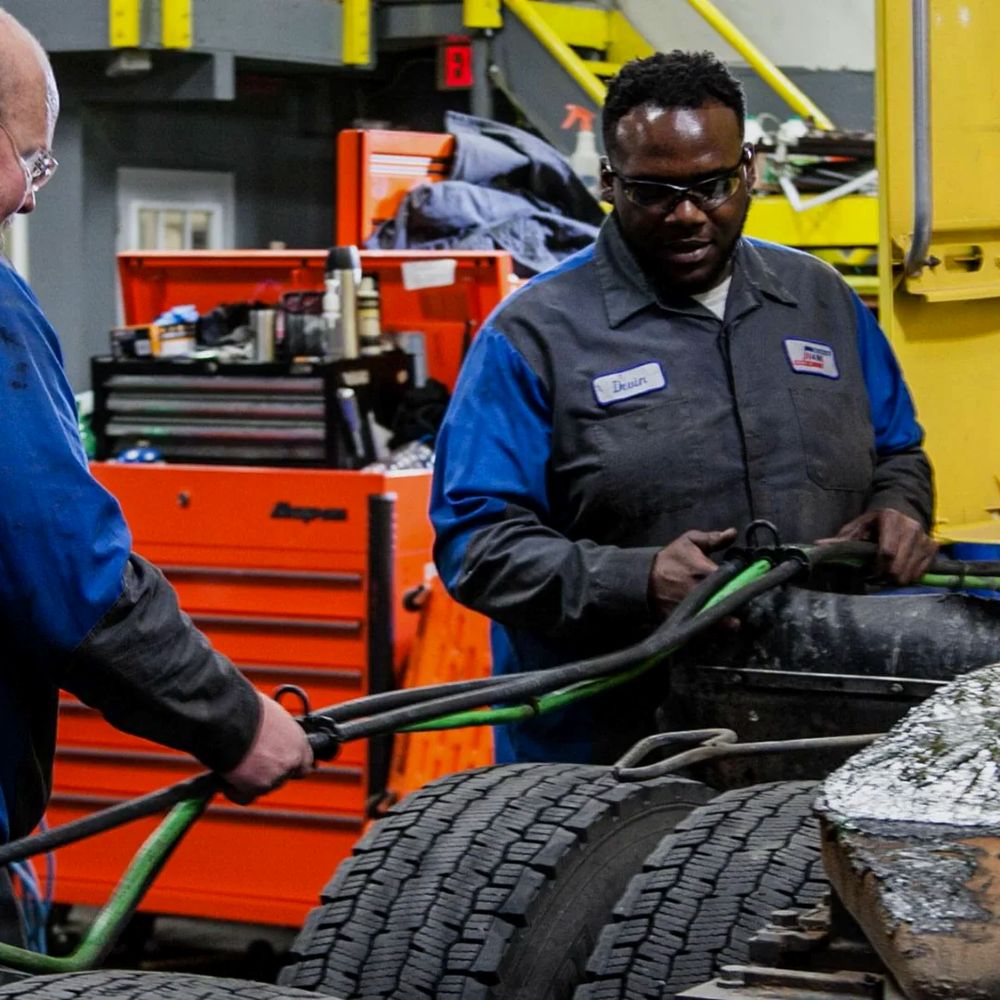 Mechanics servicing a truck in the shop